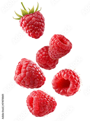 Fresh ripe raspberries falling in mid-air capturing their vibrant red color and texture