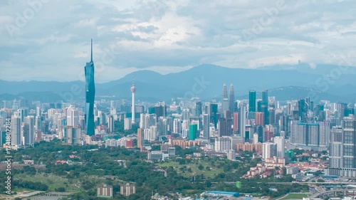 Aerial view time lapse 4k video of Kuala Lumpur city center view during dawn overlooking the city skyline in Federal Territory, Malaysia. Tilt up