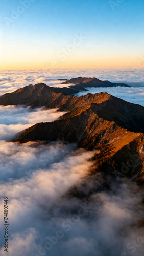 Mountain Range Above Clouds at Sunrise