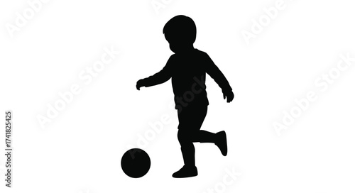 Silhouette of a young child kicking a soccer ball in motion playful childhood activity sports recreation isolated