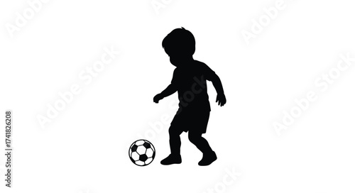 Silhouette of a young child playing soccer kicking ball childhood sports fun outdoor activity