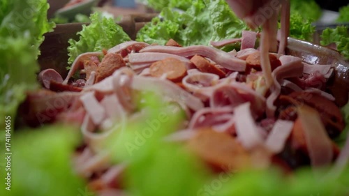 Wide shot of Guatemalan fiambre preparation for All Saints’ Day with table movement and close-up of ham plate