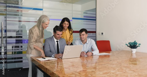 Wallpaper Mural Four multiethnic young and older teammates discussing presentation on laptop Torontodigital.ca