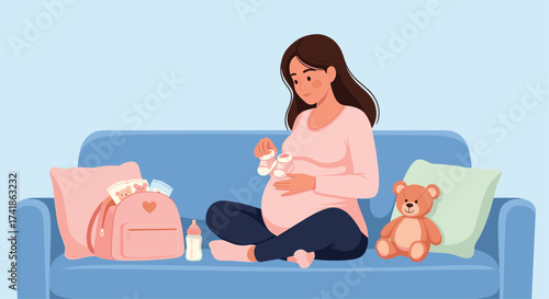 A pregnant woman sits on a sofa surrounded by baby items.