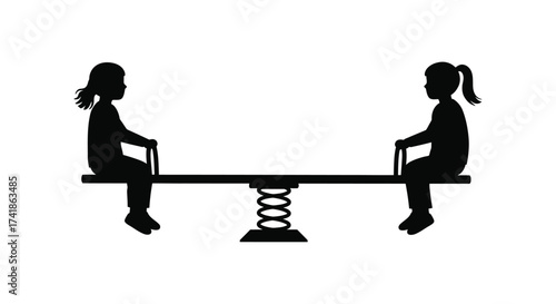 Silhouettes of two children playing on a spring loaded seesaw at a playground on a