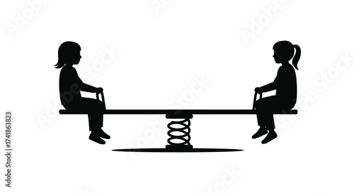 Silhouettes of two children playing on a spring-loaded seesaw enjoying outdoor park fun together