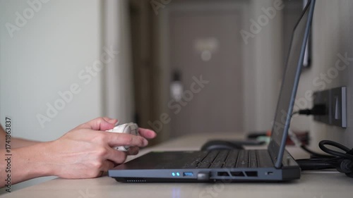 Closeup people hand or gamer holding joystick or gaming controller to enjoy playing game on computer notebook or laptop console by joy stick in living room for entertrainment relax on holiday