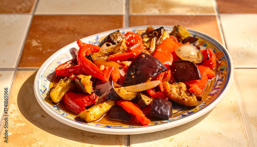A plate of Spanish escalivada with roasted peppers, eggplant, and onions