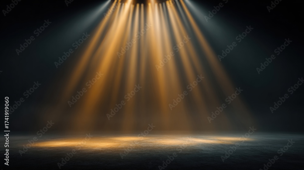 Obraz premium Blurred stage background with golden spotlight shining down, dramatic light beams cutting through haze, dreamy soft blur, dark minimal composition, wide blank copy space for text placement.