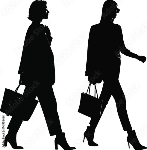 Two women in business casual attire carrying handbags walking silhouettes