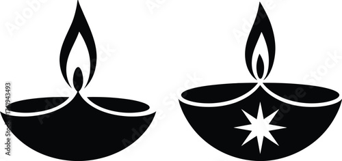 Two traditional diya oil lamps with flames symbolizing light and celebration