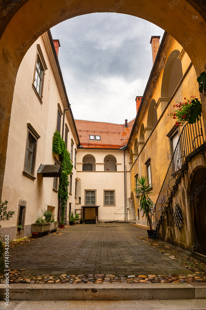 Fototapeta premium Picturesque street with arch and passageway in the city center of Maribor, Slovenia.
