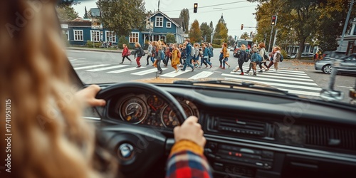 Disciplined driver stops the car at a crosswalk, allowing pedestrians to cross safely, demonstrating responsibility and respect for road safety