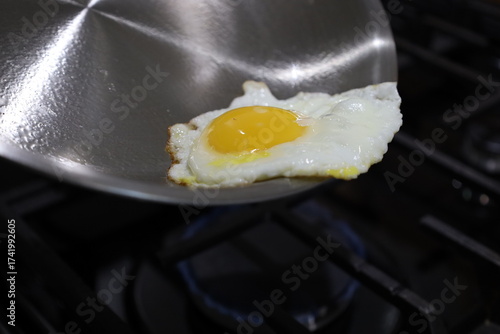 Canvas Print Stainless Steel Skillet with Sunny Side Up Egg on Gas Stove