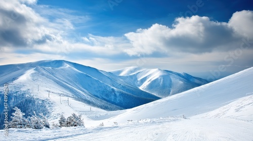 Snowy mountain range beneath a dramatic cloudy sky evoking a sense of pristine wilderness winter adventure alpine peaks snowscape cold mountain