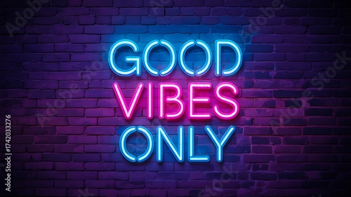 Neon good vibes only glowing motivational sign on dark brick wall background
