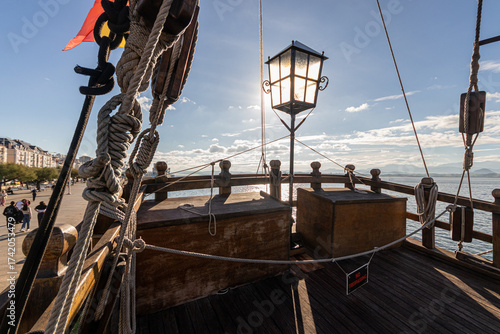 Santander, Spain. Stern lantern and large Spanish flag waving in the wind on the 2017 replica of the nao Santa Maria, the flagship of Christopher Columbus 1492 expedition, docked at the port