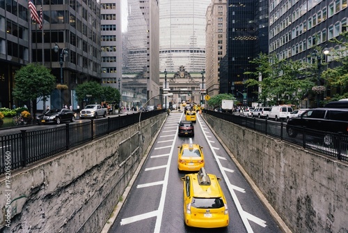 New York City street view, iconic yellow taxi cabs coming out of park avenue tunnel headed to grand central station
