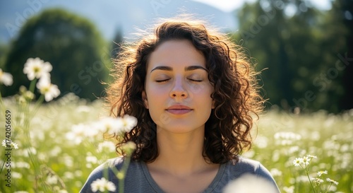 Beautiful woman practices mindfulness in a sunny flower field promoting mental wellbeing and nature appreciation