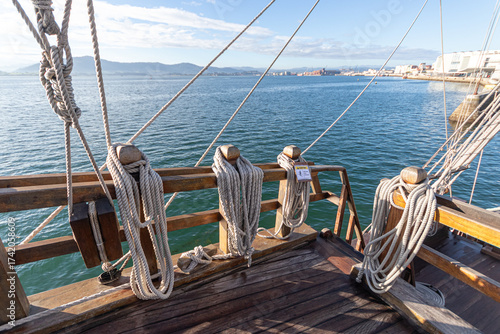 Santander, Spain. Close view of the rigging of the replica of the Santa Maria, showing the wooden blocks and pulleys used to adjust the sails of the historic 15th century caravel