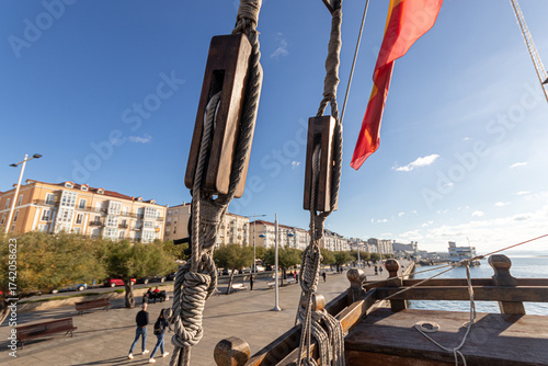 Santander, Spain. Close view of the rigging of the replica of the Santa Maria, showing the wooden blocks and pulleys used to adjust the sails of the historic 15th century caravel