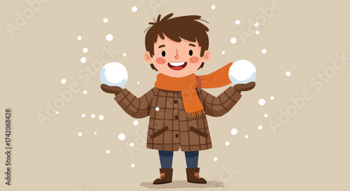 Cheerful young boy holding two snowballs dressed for winter.