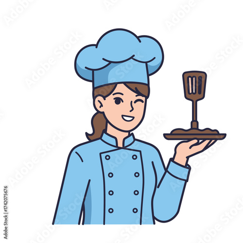 A smiling female chef in a blue uniform proudly presents a dish with a spatula, ready to serve delicious cuisine.