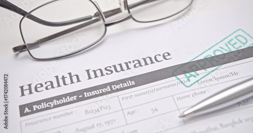 Health insurance document with APPROVED stamp, symbolizing successful medical claim, healthcare policy approval, and financial protection.