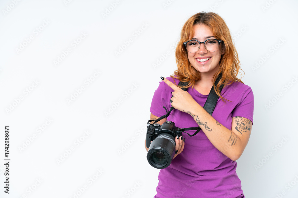 Fototapeta premium Young photographer caucasian woman isolated on white background pointing to the side to present a product