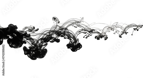 Abstract ink art featuring black pigment trails gracefully dispersing in clear water creating an