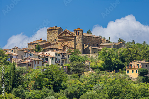 Wallpaper Mural Historic Church of Santa Maria Assunta stands majestically in Panzano, a charming village in Tuscany's Chianti region under a blue sky Torontodigital.ca