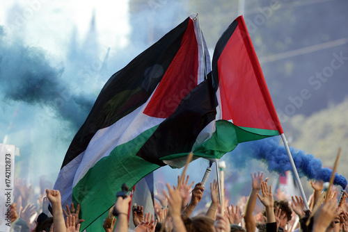 Fototapeta Naklejka Na Ścianę i Meble -  Palestinian Flags and Blue Smoke during Pro-Palestine Rally in Rome, Italy - October 4, 2025
