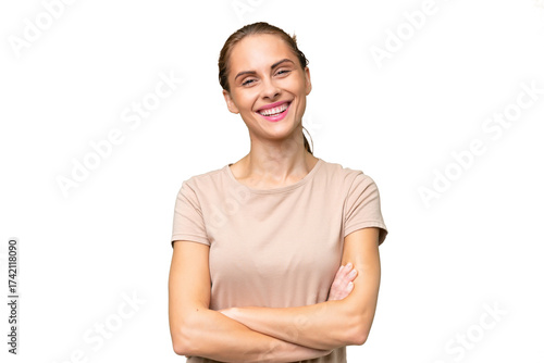 Young caucasian woman over isolated background keeping the arms crossed in frontal position