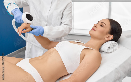 Photorejuvenation of woman arms using intense pulsed light IPL with beautician in cosmetology salon for rosacea treatment, removing brown spots and vascular mesh
