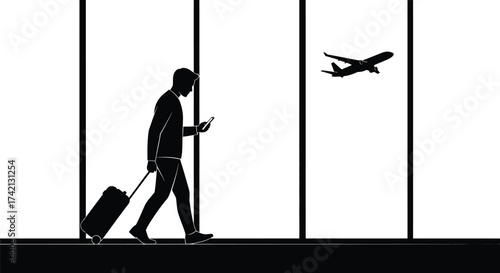 Silhouette of man with luggage looking at phone in airport with plane editable stock