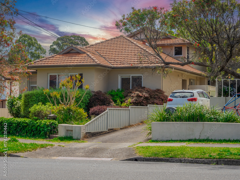 Fototapeta premium Beautiful colours of a Spring Sunset over Residential houses in inner Sydney suburb of Ashbury NSW Australia Double Bro k federation house western sydney