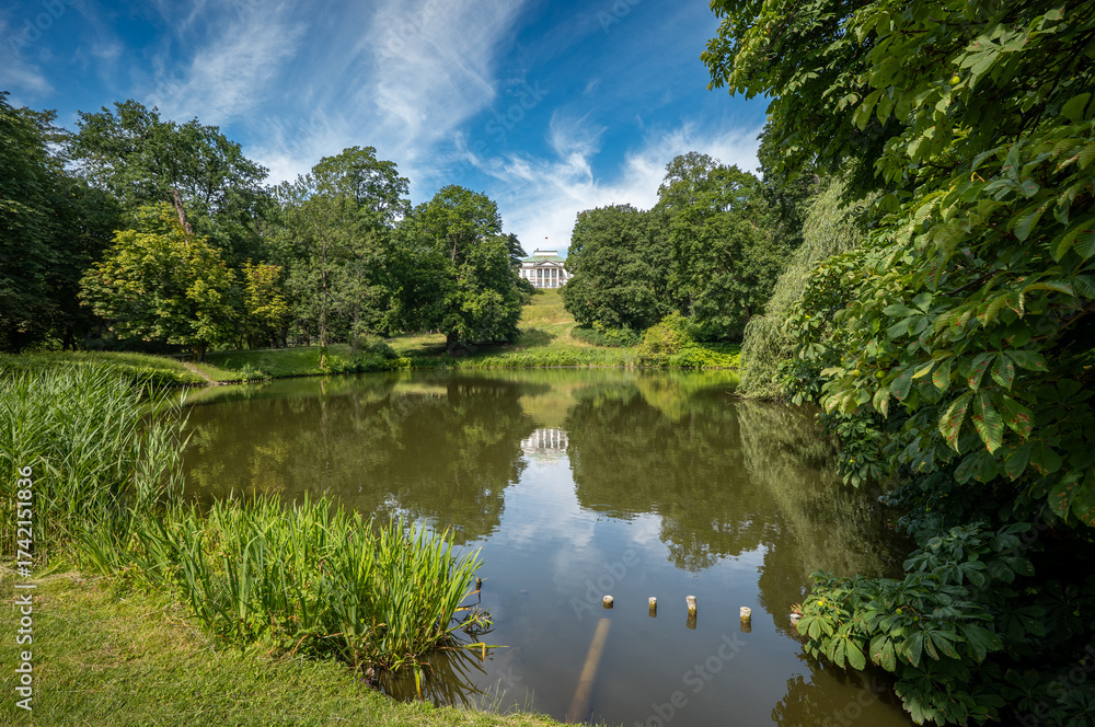 Obraz premium The Royal Lazienki Park in Warsaw in Warsaw. View toward Belweder Palace. Park pond in the foreground. Summer