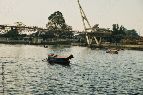 Fotografie Darul Hana Bridge in Kuching, Sarawak, Malaysia, seen from the waterfront with traditional boats operating on the Kuching River, located on the island of Borneo, Malaysia