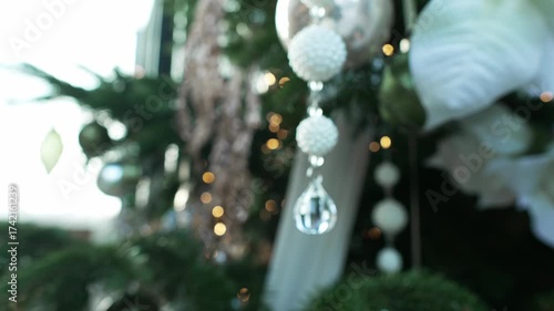 Christmas tree in shopping center is decorated with toys for New Year