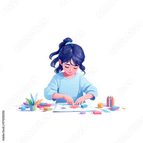 A creative young girl with dark blue hair concentrating on her colorful art project.