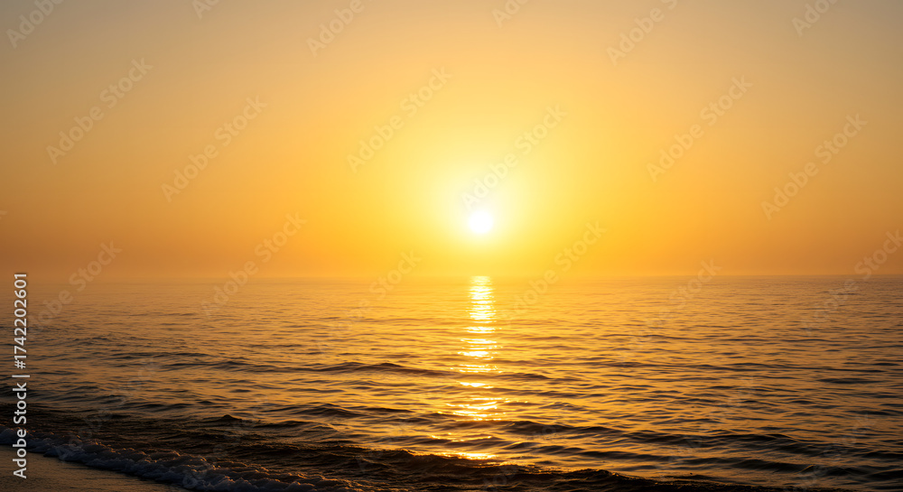 Fototapeta premium Golden Sunrise over Foggy Sea