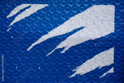 Blue bubble wrap package with aggressively peeled paper label sticker texture