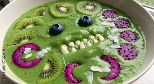 Halloween fun green smoothie bowl decorated as a smiling creature