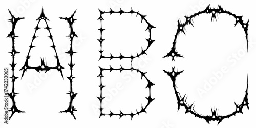 Gothic alphabet letters a b c formed from sharp thorny spikes and barbed wire on white background