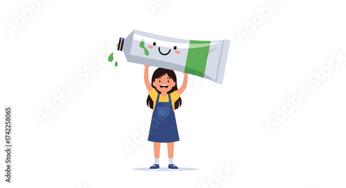 A happy girl holding up a large tube of green paint with a smiley face drawn on it.