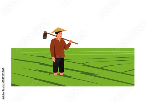 A farmer wearing a conical hat stands in a rice field, holding a hoe over his shoulder, ready for work.