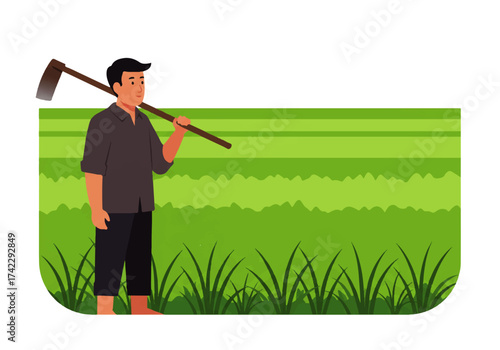 A farmer stands in a rice field, carrying a hoe over his shoulder, looking towards the field.
