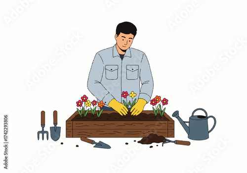Man planting colorful flowers in a wooden planter box, surrounded by gardening tools and soil.