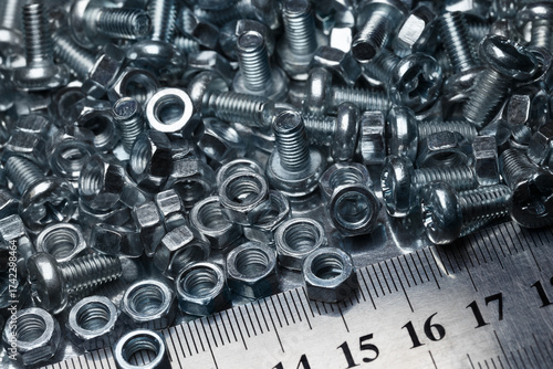 Screws, nuts and a metal ruler at the bottom