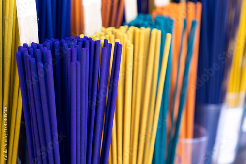 incense sticks of different colors in a traditional market
